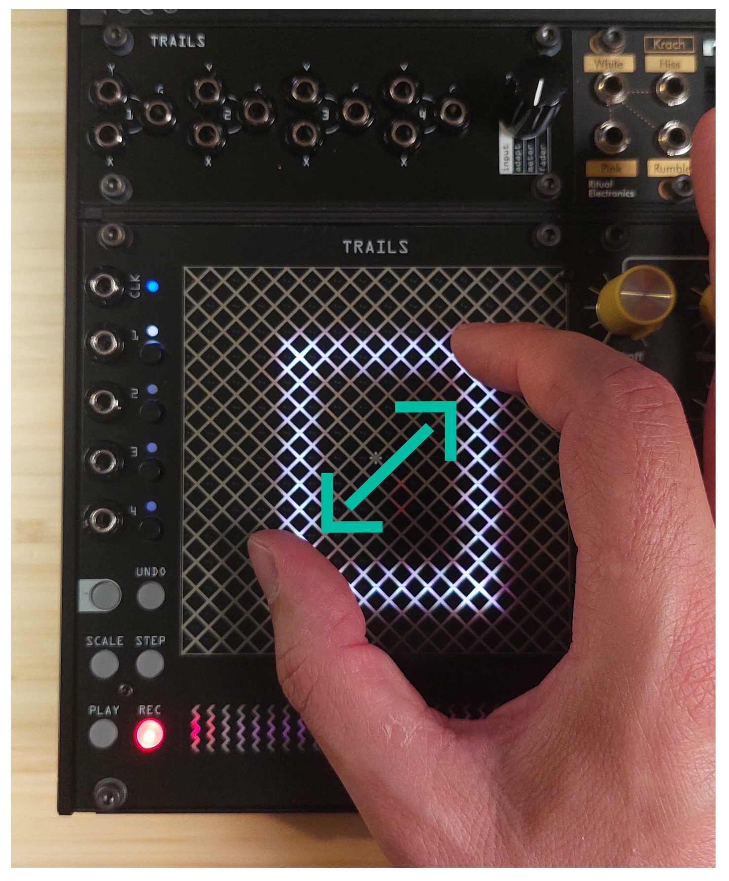 Hand performing a two-finger pinch on the touchpad